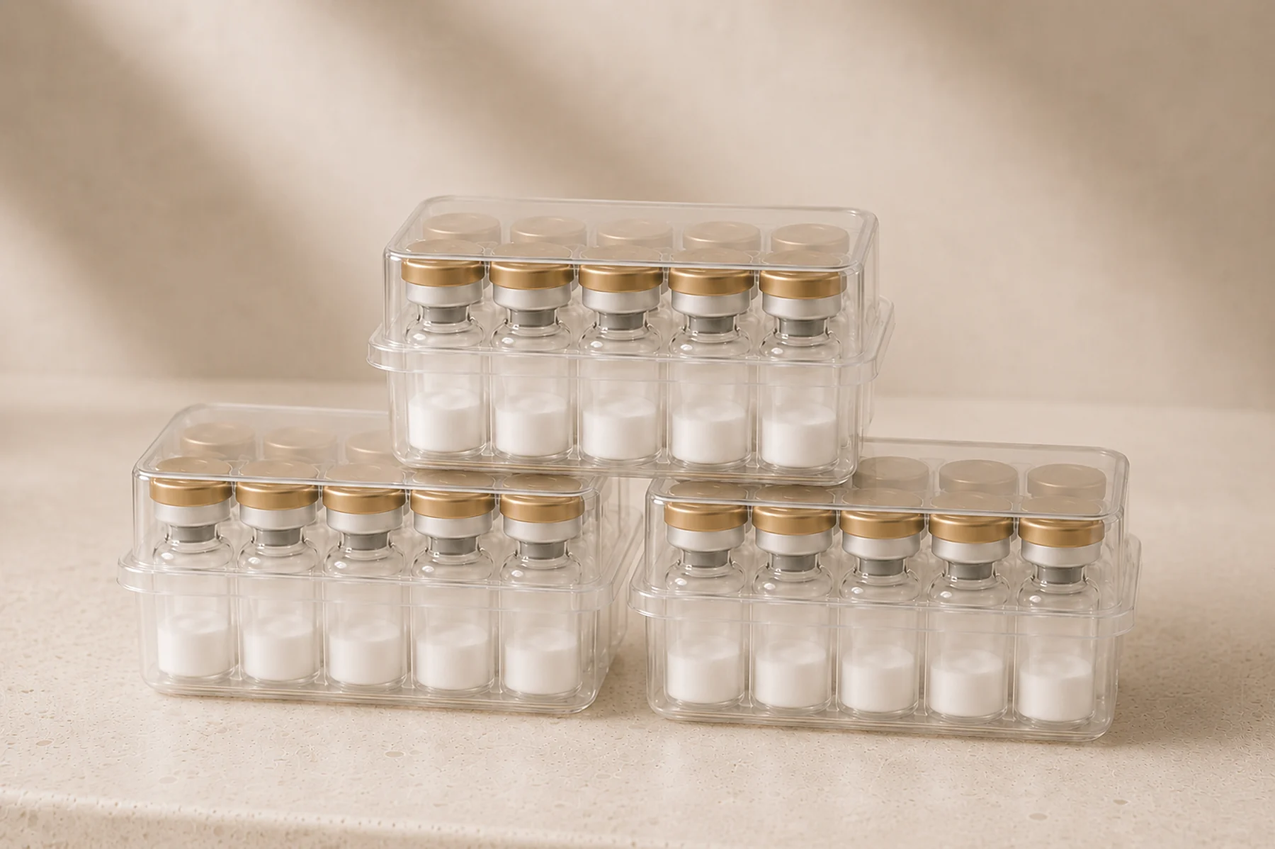 Peptx Factory Direct 10-vial kit trays stacked on a warm stone surface
